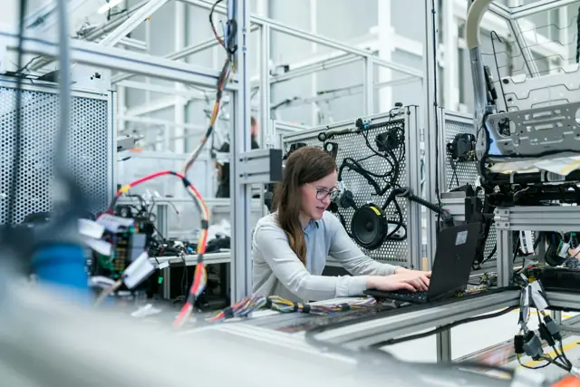 Ingeniera trabajando en una línea de manufactura automatizada